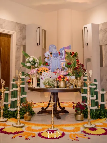 A traditional welcome setup for a Mandap Muhurat ceremony, featuring a floral rangoli, brass lamps, and a Shrinathji centerpiece. Every element is thoughtfully placed to create a blessed and beautiful beginning.