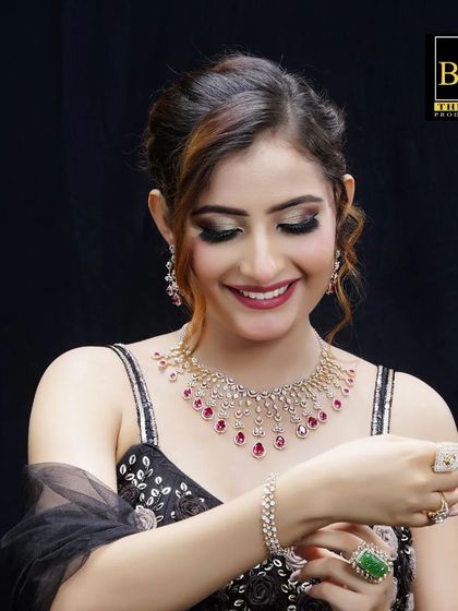 A final shot from the jewelry campaign, capturing a joyful expression. The polished updo stays perfectly in place, demonstrating its suitability for long commercial shoots while maintaining a look of effortless grace.