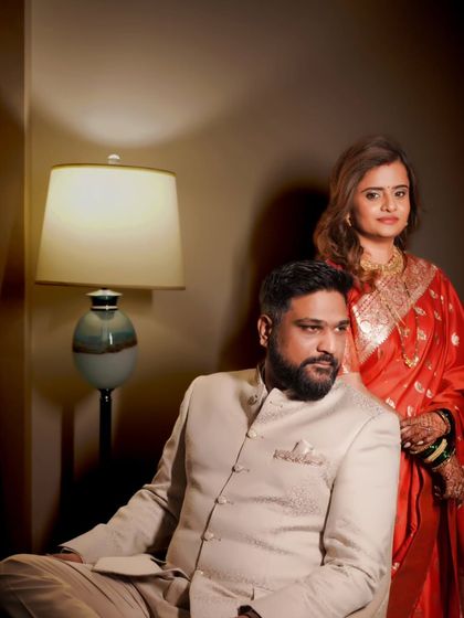 A stylish, moody portrait of the couple from their reception or sangeet event.