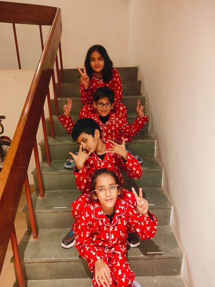 Posing on the stairs in their festive PJs. Our matching sets are designed to be comfortable enough for kids to play and have fun in.