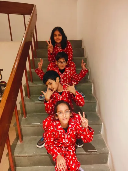 Posing on the stairs in their festive PJs. Our matching sets are designed to be comfortable enough for kids to play and have fun in.