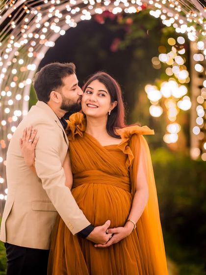A sweet kiss on the cheek inside the light tunnel, a classic pose that is made even more special by the enchanting lights.