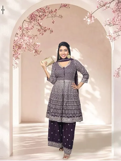 Another fantastic option for wedding guests. This purple anarkali-style suit with intricate silver work is both festive and sophisticated, perfect for making a stylish entrance.
