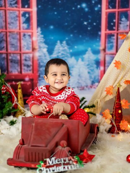 This little one is enjoying our winter wonderland setup, complete with a toy truck and a cozy sweater.