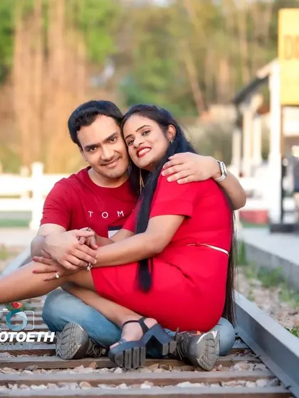 A classic and romantic pre-wedding shot on a set of train tracks. This setup symbolizes the journey the couple is taking together.