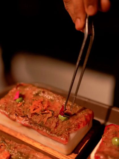For a true showstopper, I present Wagyu Phal on a hot stone. The rich, tender meat is served with sirka onions and mint sauce, creating an interactive and unforgettable main course.