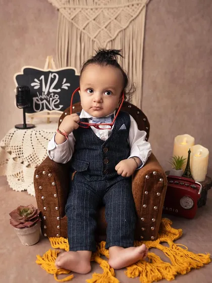 This little guy is all business, holding his glasses and looking very thoughtful. The 'halfway to one' theme is a fun way to mark the 6-month milestone.