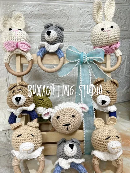The soft touch of handmade items adds so much warmth. These crochet rattles, shaped like bunnies, bears, and sheep, are some of my favorite items to include in baby hampers. They are safe, adorable, and a timeless keepsake for a new baby.