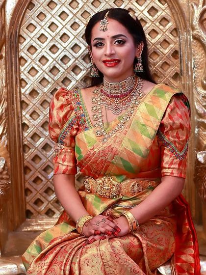 A beautiful portrait of Lakshmishri on her ornate wedding chair. Her makeup was designed to be both traditional and powerful, perfect for a bride on her big day.