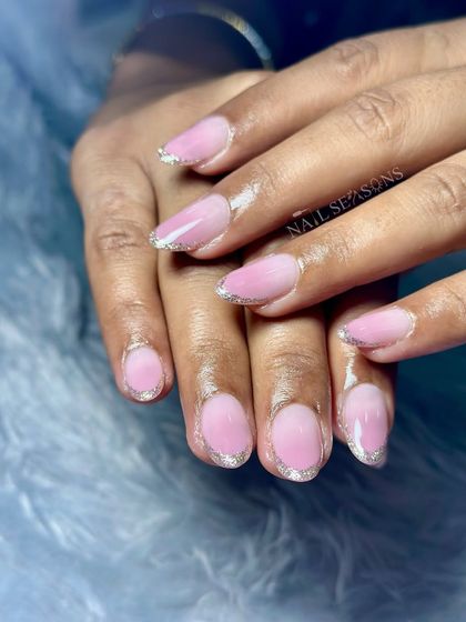 A soft pink ombre with a delicate silver glitter French tip.