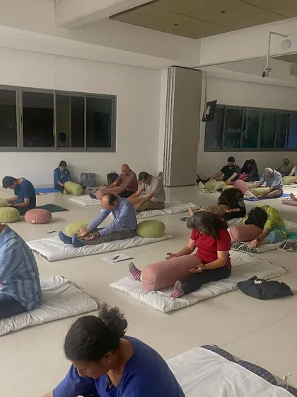 A group of participants fully engaged in a floor exercise during a community wellness event. My goal is to make mindfulness accessible, providing tools and guidance that can be practiced anywhere, from the office to a public forum.