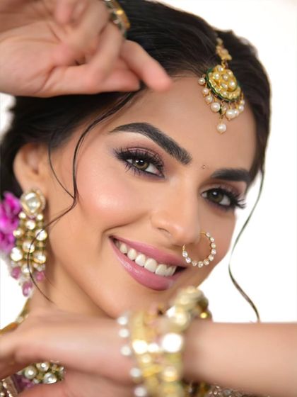 A happy, smiling close-up. The makeup is designed to look perfect in photos and make the bride feel her absolute best.