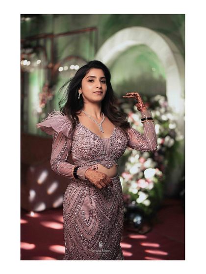 A solo portrait of the bride in her glamorous reception gown, her hair catching the wind as she moves.