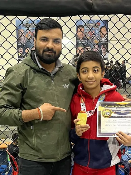 I am here with one of our champions at the 2nd Indian Open MMA Championship in Jabalpur. He is proudly holding his gold medal and certificate, a reward for his tough fight and hard work.