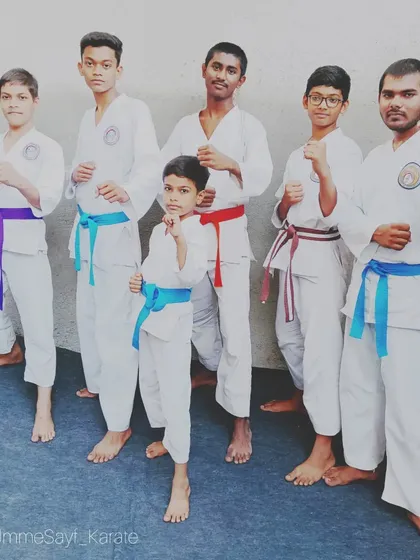 "Fall down seven times, stand up eight." Our karate team, a mix of belts and ages, standing strong and ready to train.