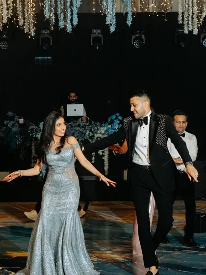 A candid moment of joy during a couple's sangeet dance. We choreograph routines that are as fun to perform as they are to watch.