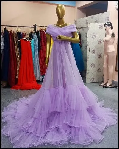 Our lavender ruffled gown is a fairytale dream come true. The soft pastel color and voluminous tiered skirt create a whimsical and romantic look, shown here on a mannequin.