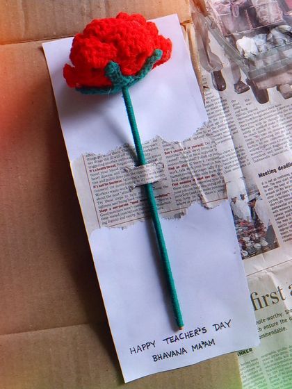 A close-up of one of the custom Teacher's Day rose cards. Each one is personalized with the teacher's name.