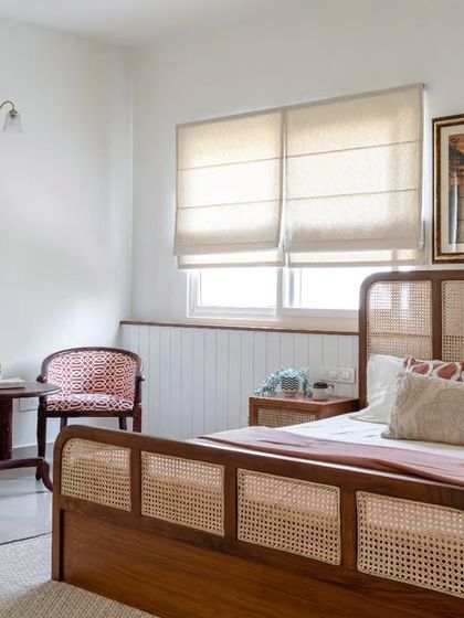 Another angle of the parent's guest room, showing the plush upholstery of the antique chairs and the warm, woody ambiance created by the furniture and paneling.