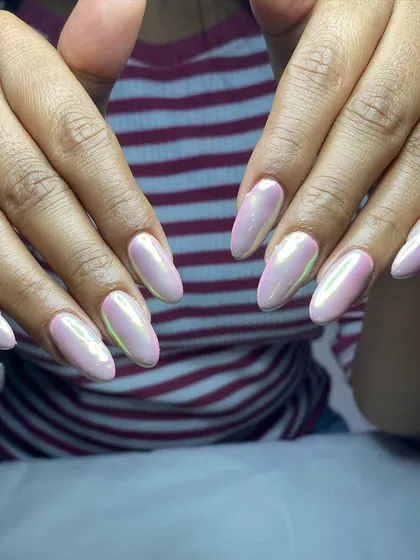 A close-up of the unicorn chrome nails, highlighting the smooth surface and clean application around the cuticles.