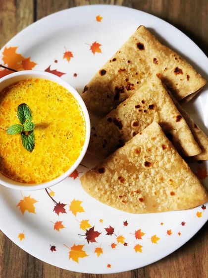 This is my special Doodh ki Sabji, or Milk Curry. It's a unique and creamy curry that pairs wonderfully with hot chapattis or parathas, garnished with a mint leaf.