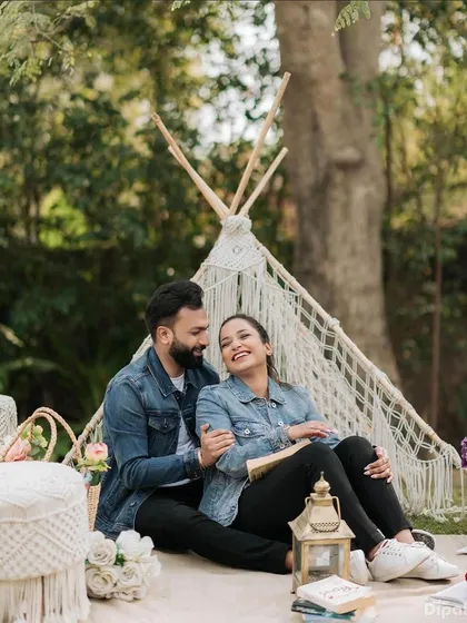 A fun and casual pre-wedding picnic scene. The makeup is minimal and natural, perfect for a relaxed, daytime shoot.