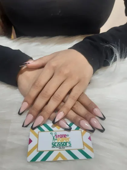 Here's my modern take on the classic French manicure. I used sharp, black V-shaped tips on long, stiletto nail extensions for a chic and powerful look that stands out.