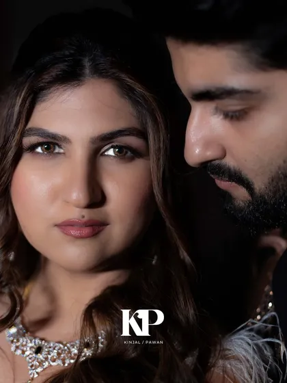 A dramatic and intimate close-up portrait from a cocktail night. The lighting and her intense gaze create a powerful, cinematic feel. This is a modern, glamorous bridal look.