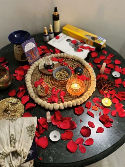 The altar for our "Women & the Moon" workshop, adorned with rose petals, crystals, and oracle cards to honor the sacred feminine energy.