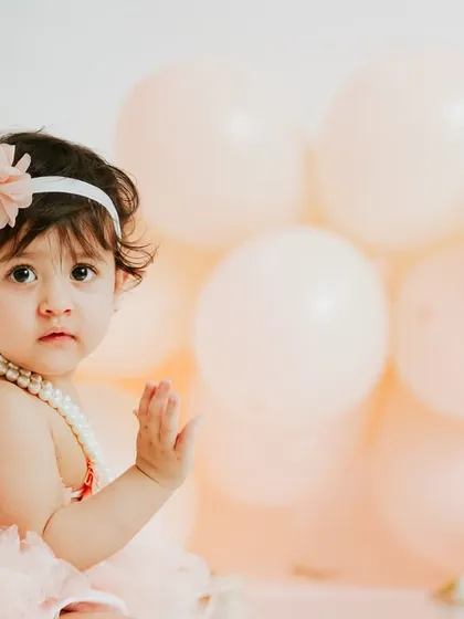 A sweet wave to the camera. The simplicity of the setup allows her personality to be the star of the show.