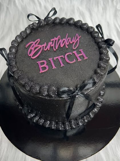 For the "Birthday Bitch" who deserves to be celebrated. This all-black vintage-style cake with a hot pink acrylic topper is edgy, chic, and full of attitude.