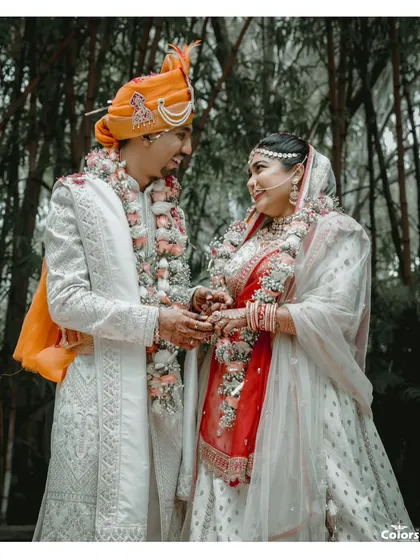 A beautiful portrait of the couple during their wedding ceremony, sharing a quiet look amidst the rituals.