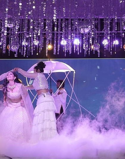 A duplicate of image 21, this angle highlights the ethereal quality of the performance, with the lighting, smoke, and props all working together.