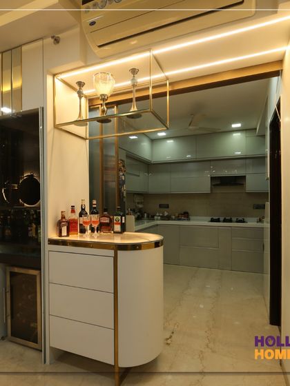This bespoke bar unit features a curved counter, a suspended glass holder, and warm accent lighting, creating a sophisticated corner for entertaining.
