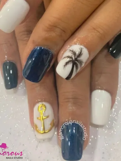 A nautical-themed set perfect for a vacation, combining white, navy, and dark green nails with hand-painted palm tree and 3D anchor designs.