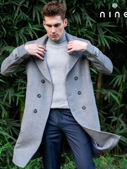 A dynamic shot of the overcoat, showing the quality of the fabric and its excellent drape.