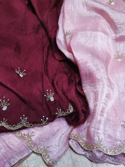 A dual-tone crush tissue saree in pink and maroon, both adorned with delicate embroidery. This piece shows how you can play with colors while enjoying the comfort of this beautiful fabric.