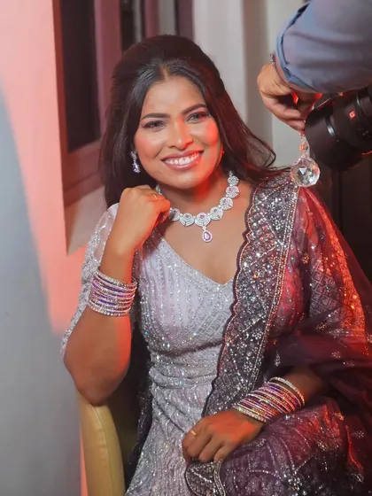 A happy, smiling bride during her reception. The makeup is designed to look great in photos and in person, capturing her joy perfectly.