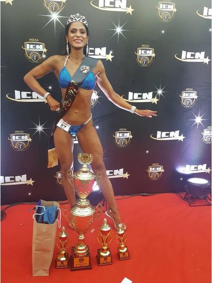 Posing with all my trophies after being crowned the ICN India Bikini Overall Champion. A moment of pure joy and accomplishment.