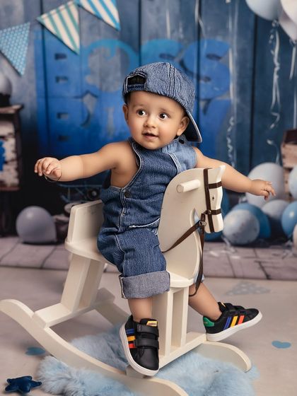 A ride on the rocking horse for this denim-clad cutie. This is another fun shot from my 'Boss Baby' inspired collection, showing a more playful and casual side of the theme.