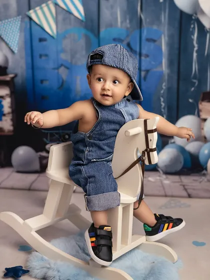 A ride on the rocking horse for this denim-clad cutie. This is another fun shot from my 'Boss Baby' inspired collection, showing a more playful and casual side of the theme.