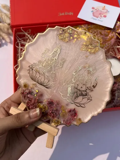 A lovely Diwali hamper featuring a resin art piece with Lakshmi and Ganesha, perfect for gifting.