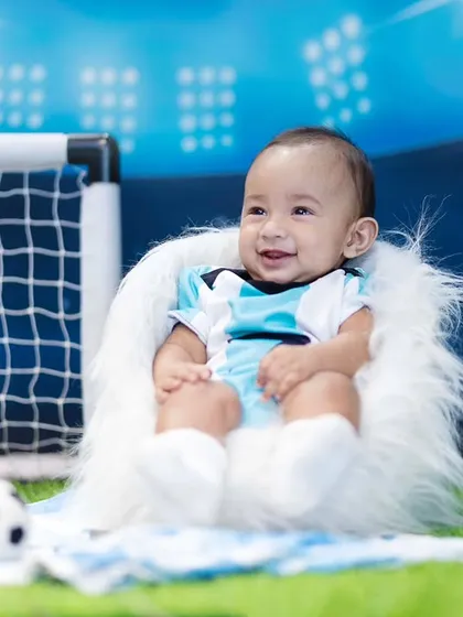 Even the smallest players can have big goals. This sitter session features a fun football theme, complete with a tiny jersey and soccer balls, perfect for capturing a baby's playful spirit.