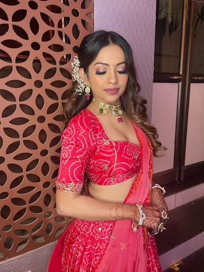 Makeup and hairstyle goals. This look in a red bandhani lehenga is guaranteed to make you shine.