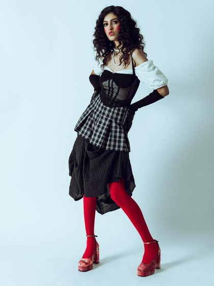 A full-length look from a vintage-modern fusion concept. The styling, with its layers and pop of color, tells a story of playful rebellion.