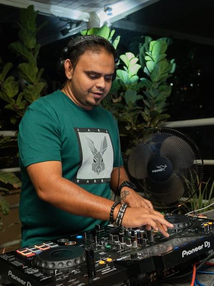 A quiet moment of focus at the decks before the night kicks into high gear.