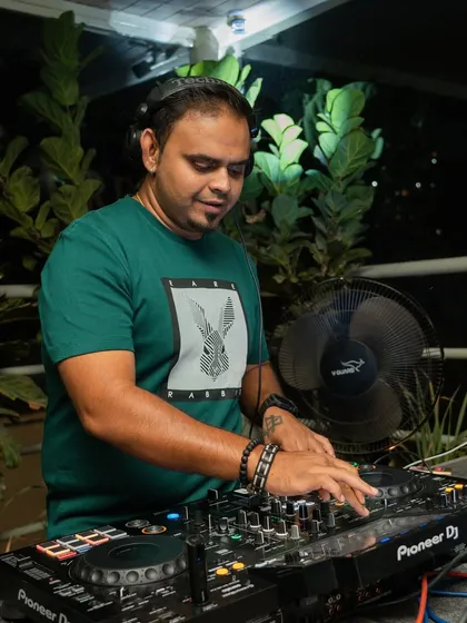 A quiet moment of focus at the decks before the night kicks into high gear.