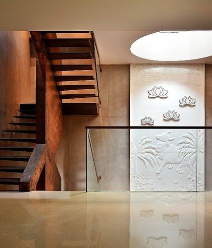 A view of the staircase landing, where the play of light and shadow from the skylight above brings the space to life.
