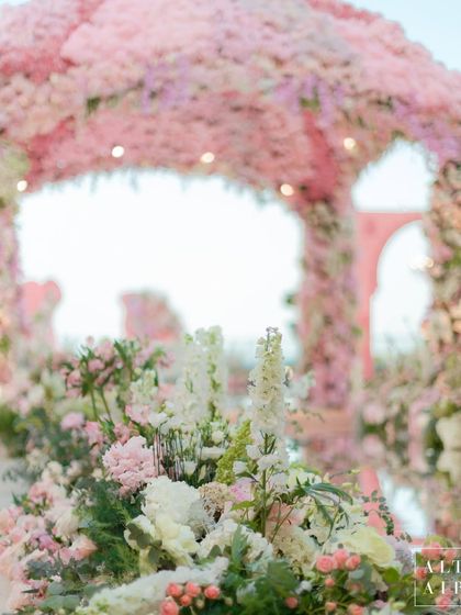 A close-up of the floral aisle at the 'Echoes of Pink' wedding. The path was lined with lush arrangements, creating a beautiful and fragrant journey for the bride.