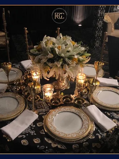 We create elegant dining experiences with meticulous attention to detail. This formal sit-down setting features our fine china, gold-accented cutlery, and a beautiful floral centerpiece, perfect for an intimate, upscale dinner.